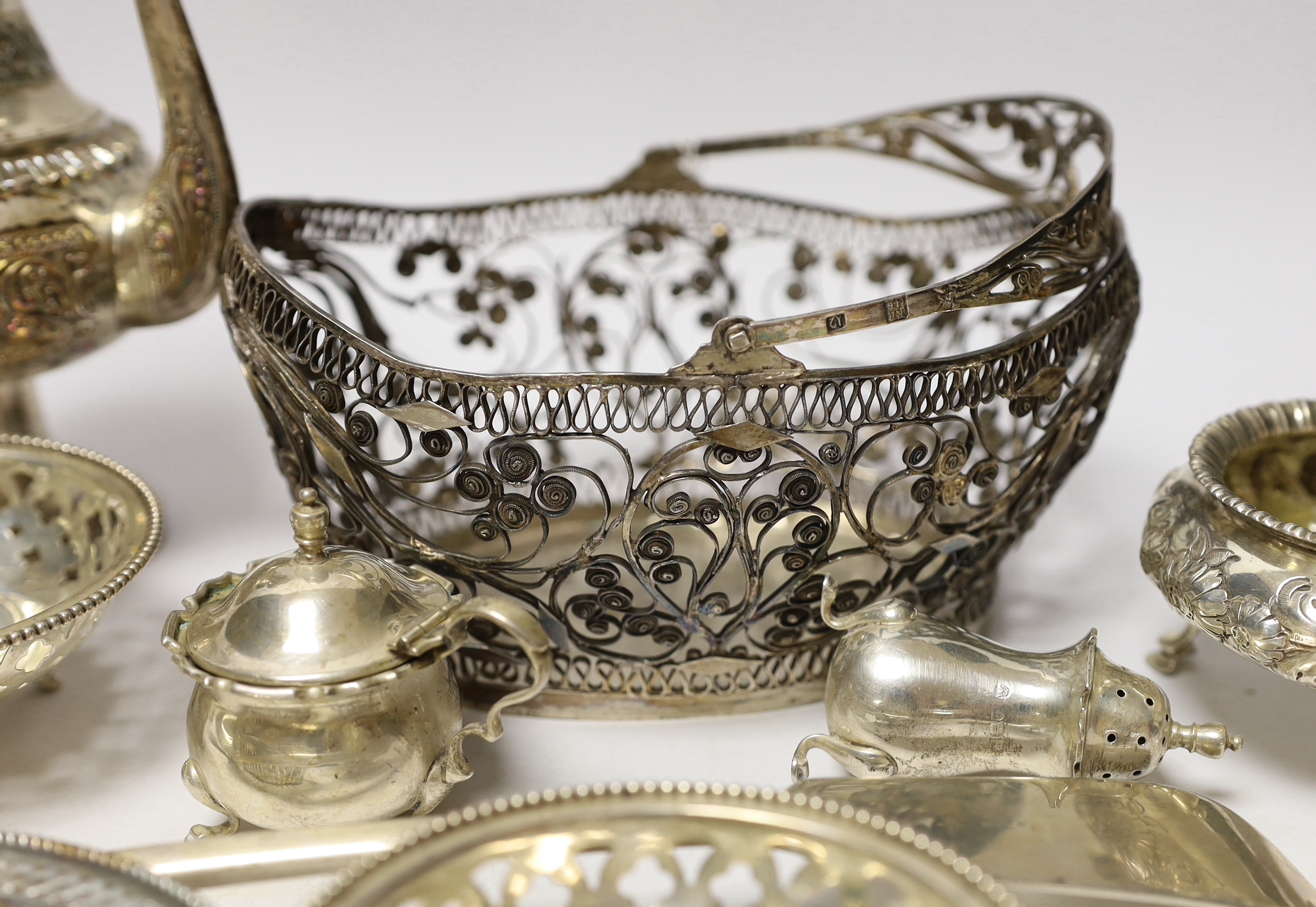 A quantity of silver and white metal items including a continental filigree basket, small silver bonbon dish, George III soup ladle, salts, Victorian silver mustard, etc.